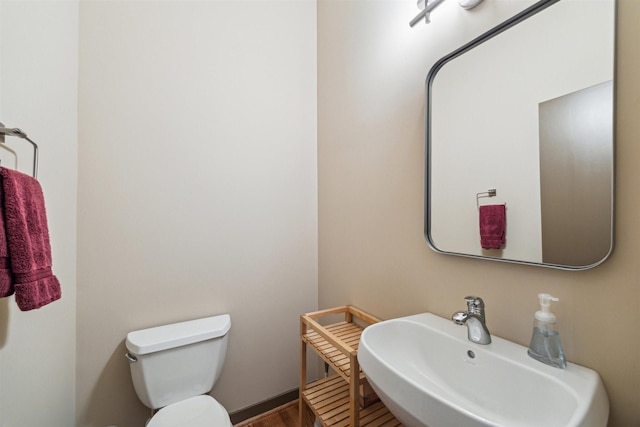 bathroom featuring sink and toilet