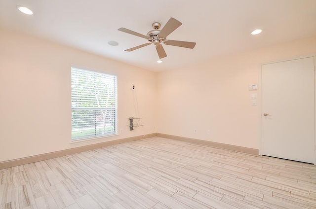 empty room featuring ceiling fan and light hardwood / wood-style floors