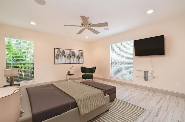 bedroom with multiple windows, light wood-type flooring, and ceiling fan