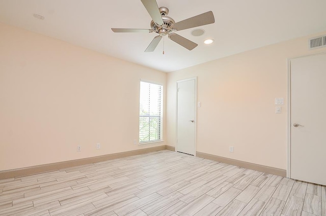 spare room featuring ceiling fan and light wood-type flooring