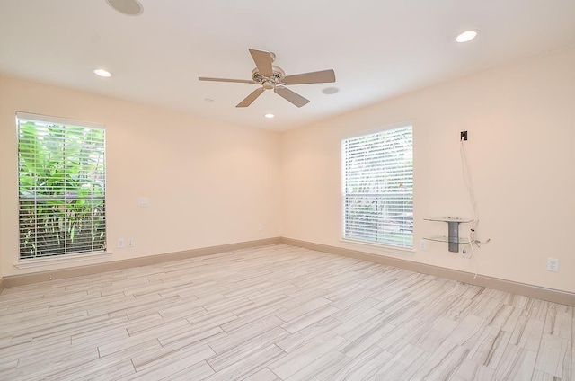 spare room featuring light hardwood / wood-style floors and ceiling fan