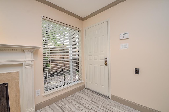 foyer entrance featuring crown molding and plenty of natural light