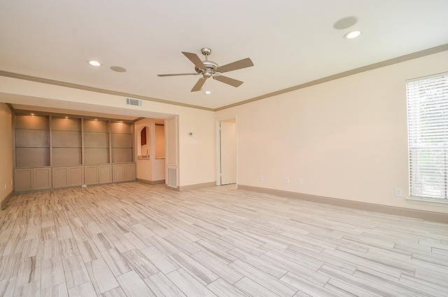 spare room with light wood-type flooring, ceiling fan, and ornamental molding