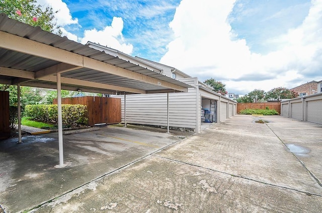 view of vehicle parking with a garage and a carport