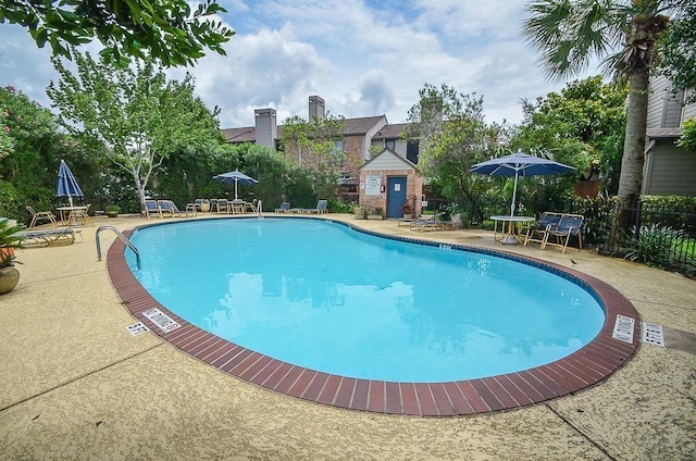 view of swimming pool with a patio area