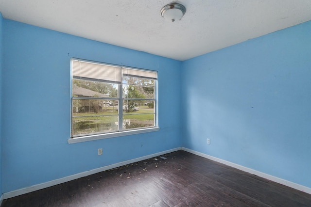 empty room with dark wood-type flooring