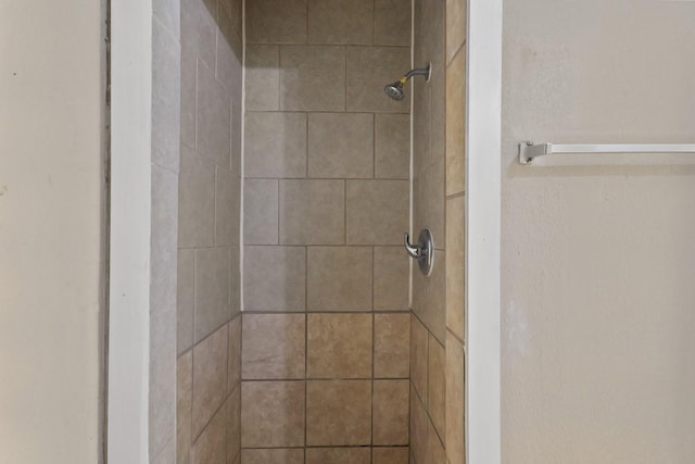 bathroom with a tile shower