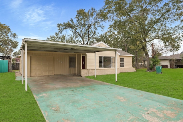 rear view of house featuring a yard, a carport, and a garage