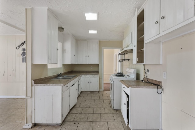 kitchen featuring a textured ceiling, sink, white cabinets, and white stove