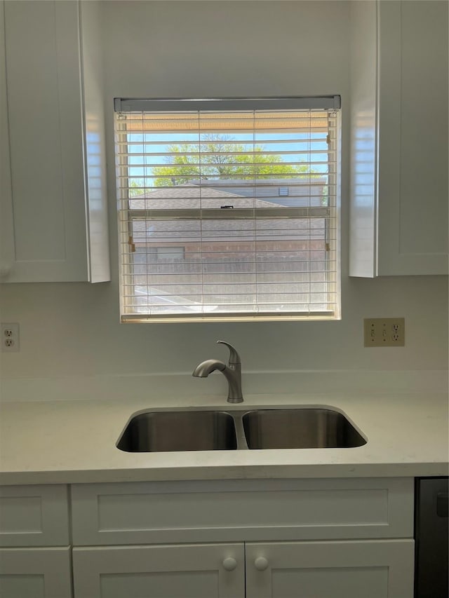 kitchen featuring sink, white cabinets, and a healthy amount of sunlight