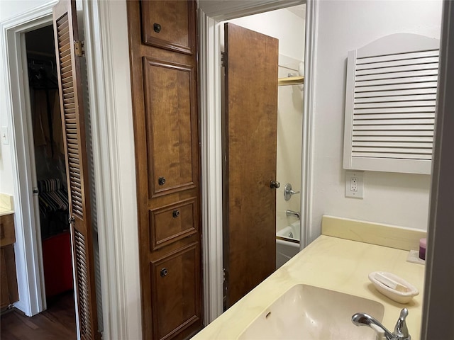 bathroom featuring vanity and combined bath / shower with glass door