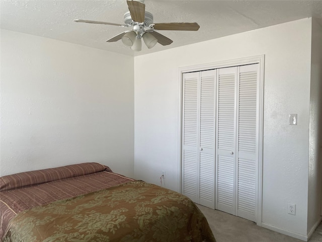 bedroom with carpet, a closet, and ceiling fan