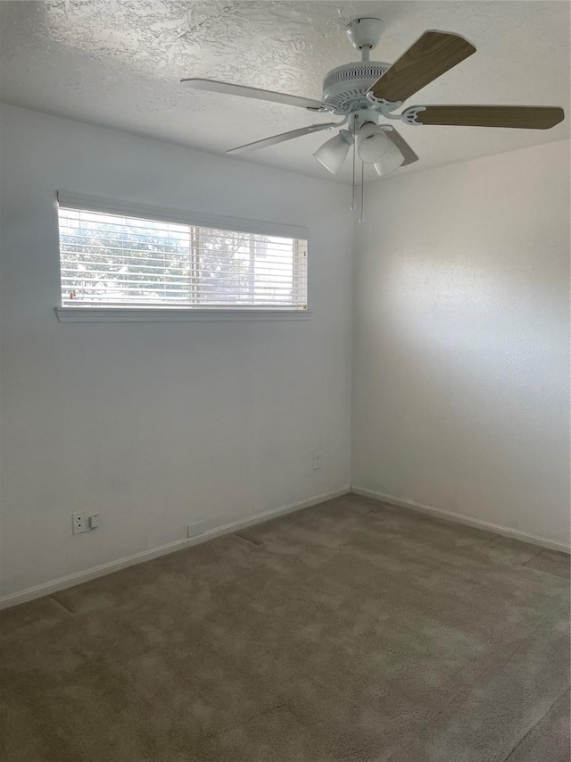 empty room with carpet, a textured ceiling, a wealth of natural light, and ceiling fan