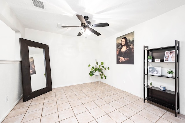 unfurnished room featuring ceiling fan and light tile patterned floors