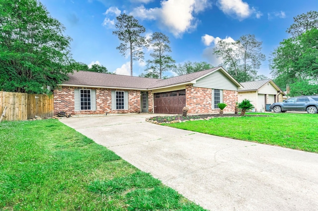 single story home featuring a front lawn and a garage