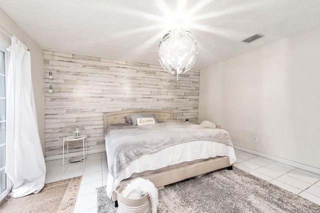 bedroom with light tile patterned floors and a textured ceiling