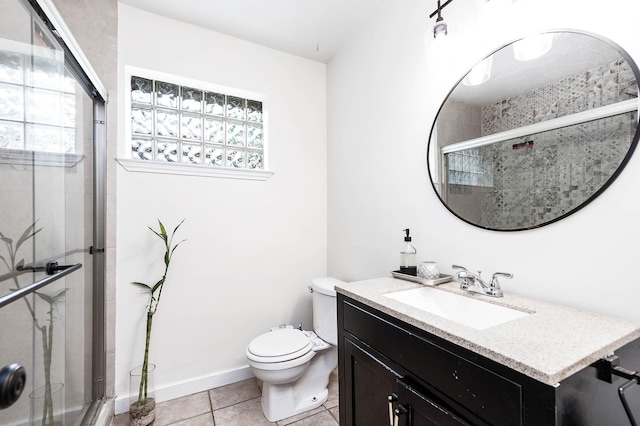 bathroom featuring tile patterned floors, toilet, vanity, and walk in shower