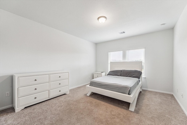 bedroom featuring light colored carpet