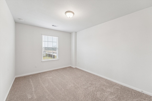 unfurnished room featuring carpet flooring