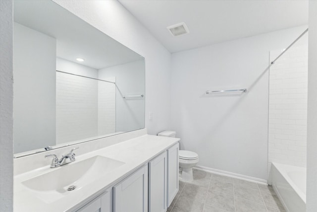 full bathroom featuring tile patterned floors, vanity, toilet, and tiled shower / bath combo