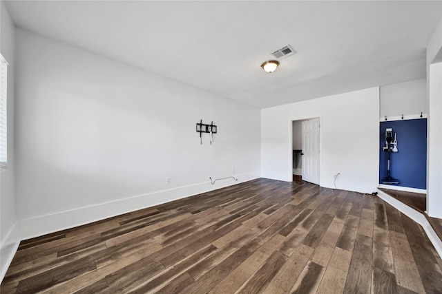 spare room with dark wood-type flooring