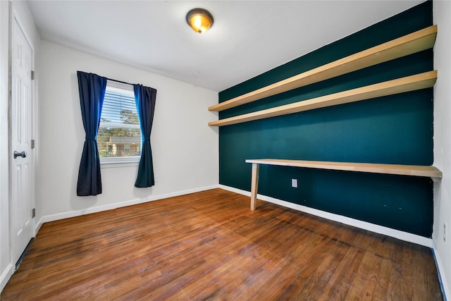 unfurnished room with wood-type flooring