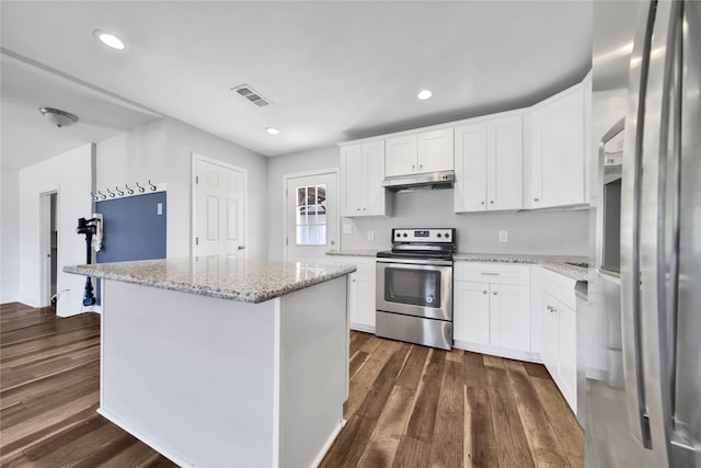 kitchen featuring a center island, dark wood-type flooring, white cabinets, appliances with stainless steel finishes, and light stone counters