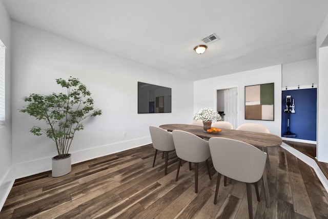 dining space with dark wood-type flooring