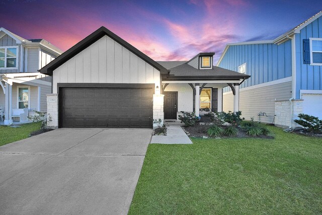 view of front of house with a garage and a lawn