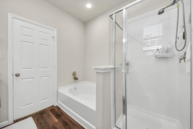 bathroom featuring hardwood / wood-style floors and independent shower and bath