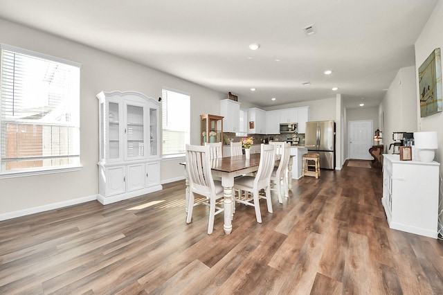 dining area with dark hardwood / wood-style floors