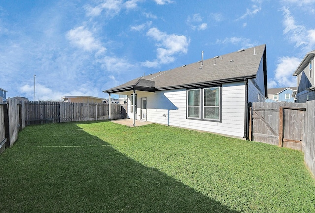 rear view of house with a patio area and a yard