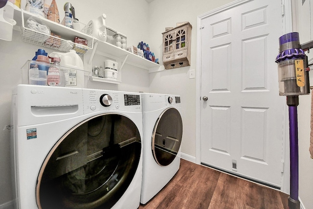 washroom with washing machine and dryer and dark hardwood / wood-style floors