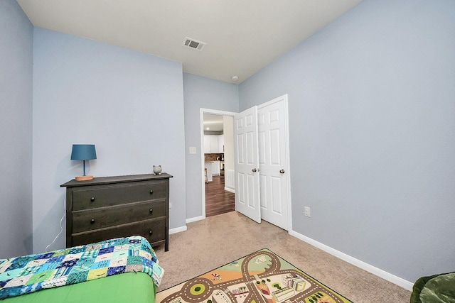 bedroom featuring light carpet