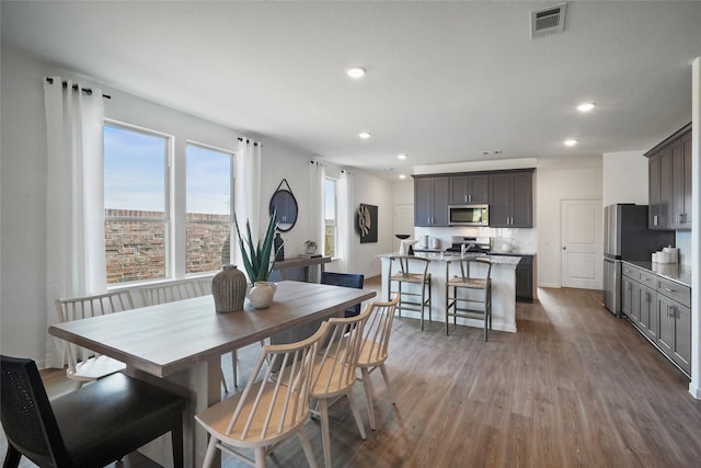 dining area with dark hardwood / wood-style flooring