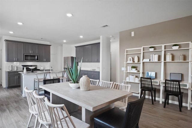 dining area with dark hardwood / wood-style flooring