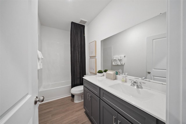 full bathroom featuring wood-type flooring, vanity, toilet, and shower / tub combo with curtain