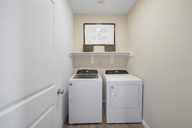 washroom featuring washer and clothes dryer and hardwood / wood-style floors