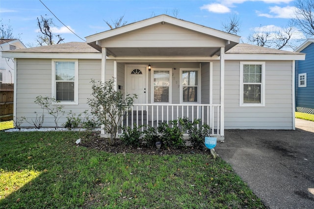 view of front of home with covered porch and a front yard