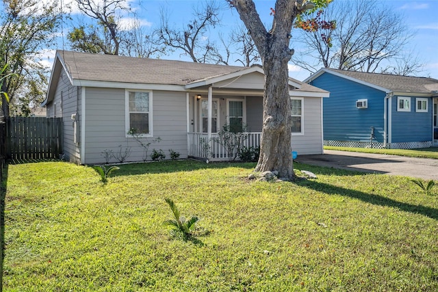 ranch-style house with a porch and a front lawn