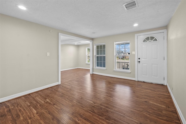 entryway featuring a textured ceiling and dark hardwood / wood-style floors