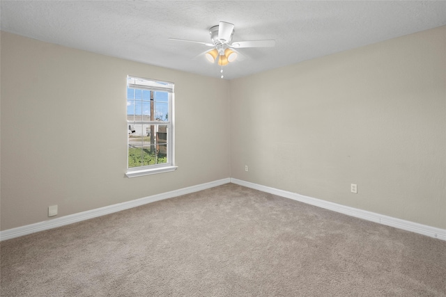 carpeted empty room featuring a textured ceiling and ceiling fan