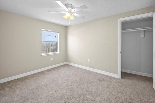 unfurnished bedroom featuring carpet, a closet, and ceiling fan