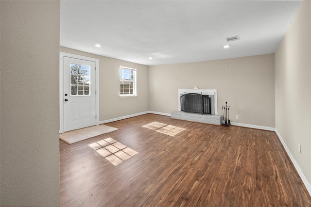 unfurnished living room featuring hardwood / wood-style floors and a fireplace