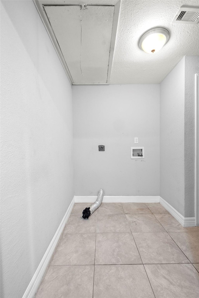 laundry room featuring hookup for a washing machine, light tile patterned flooring, a textured ceiling, and hookup for an electric dryer