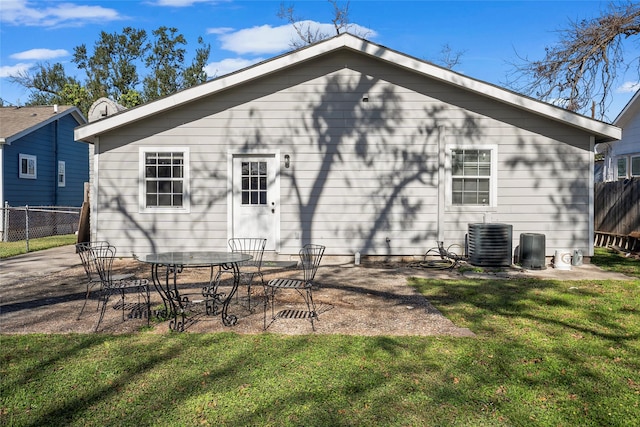 back of house featuring a yard, a patio, and central AC