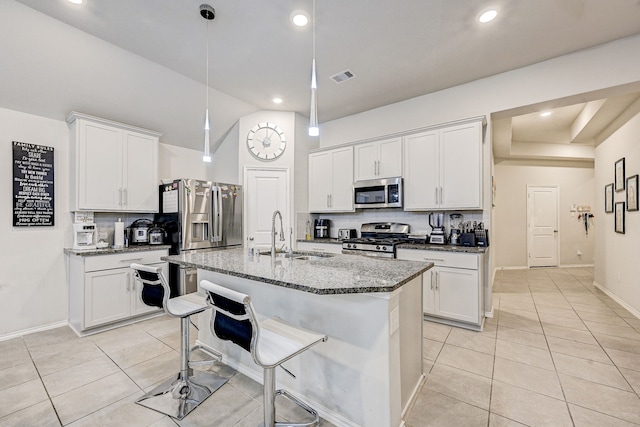 kitchen featuring white cabinets, dark stone counters, sink, and stainless steel appliances