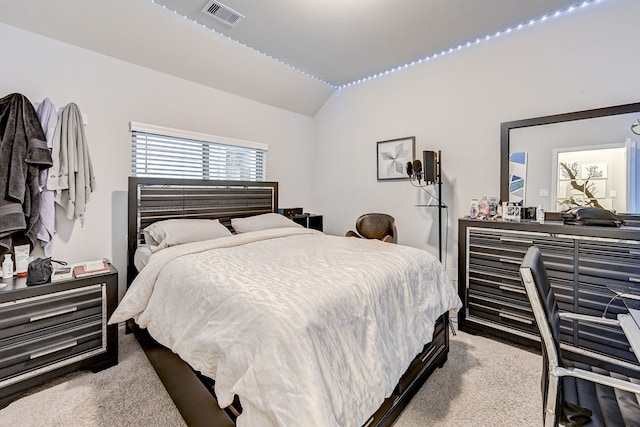 carpeted bedroom with lofted ceiling