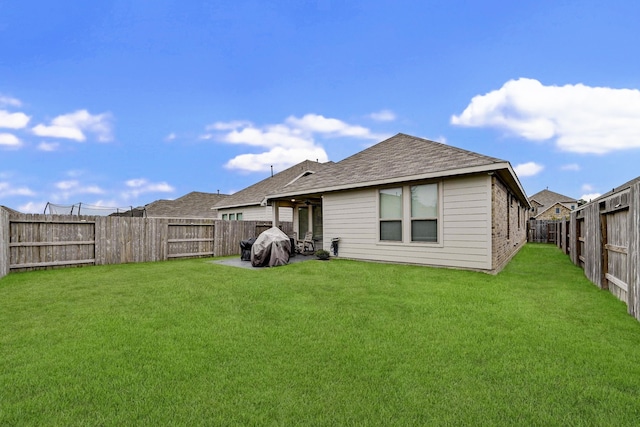 rear view of house with a yard