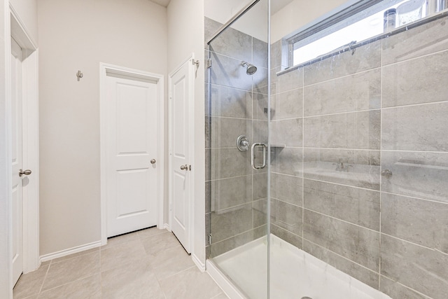 bathroom featuring walk in shower and tile patterned flooring